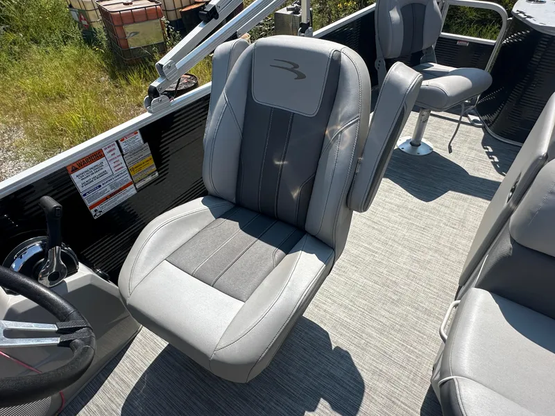 Slide: The Image of 2020 Bennington SX 20 SFX boat interior with gray captain's chair and steering wheel. - 14