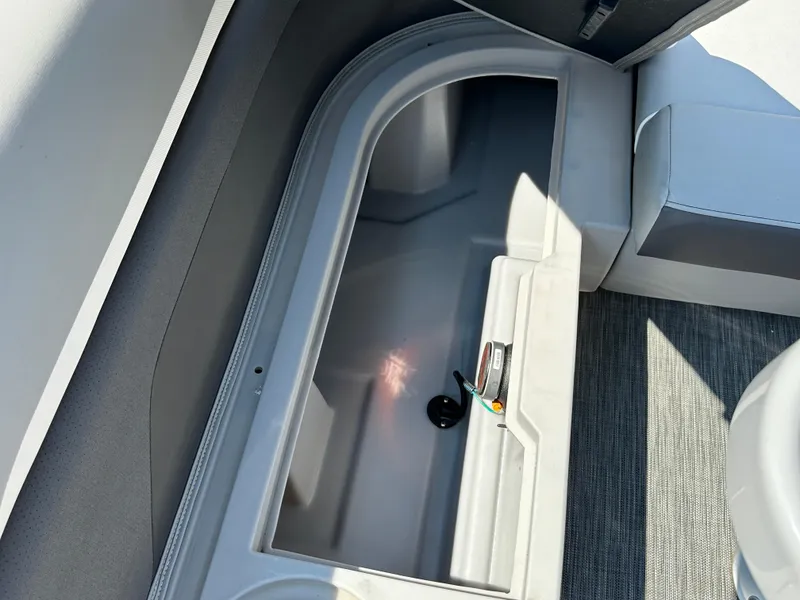 Slide: The Image of Open storage compartment in 2020 Bennington SX 20 SFX boat interior. - 16