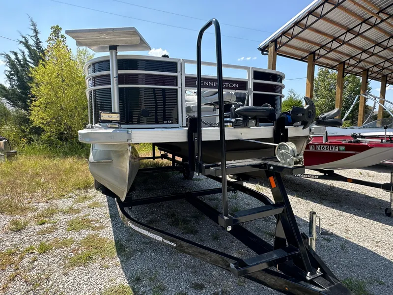 Slide: The Image of 2020 Bennington SX 20 SFX pontoon boat on trailer in outdoor storage. - 2