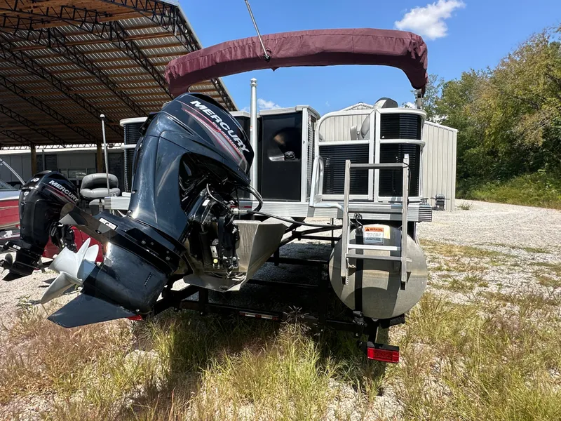 Slide: The Image of 2020 Bennington SX 20 SFX pontoon boat with Mercury outboard motor, parked outdoors. - 5
