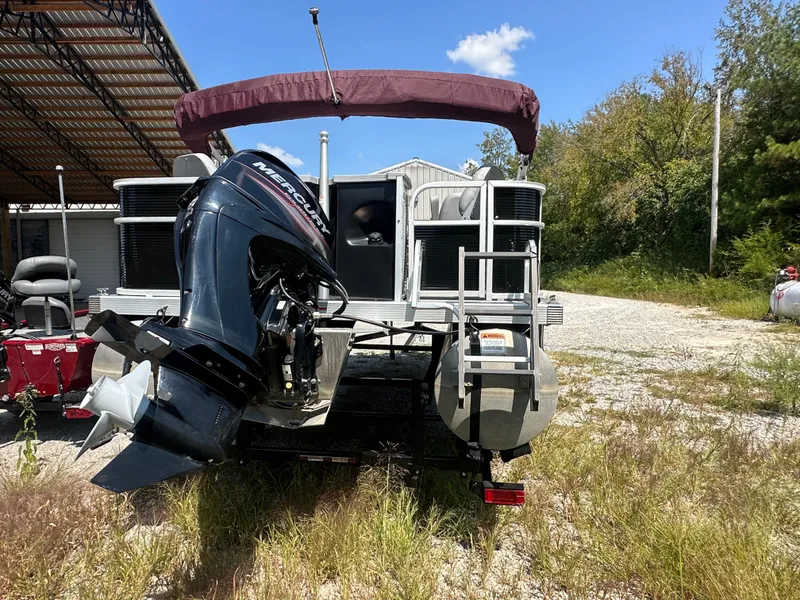 Slide: The Image of 2020 Bennington SX 20 SFX pontoon boat with Mercury outboard motor in a sunny outdoor setting. - 6