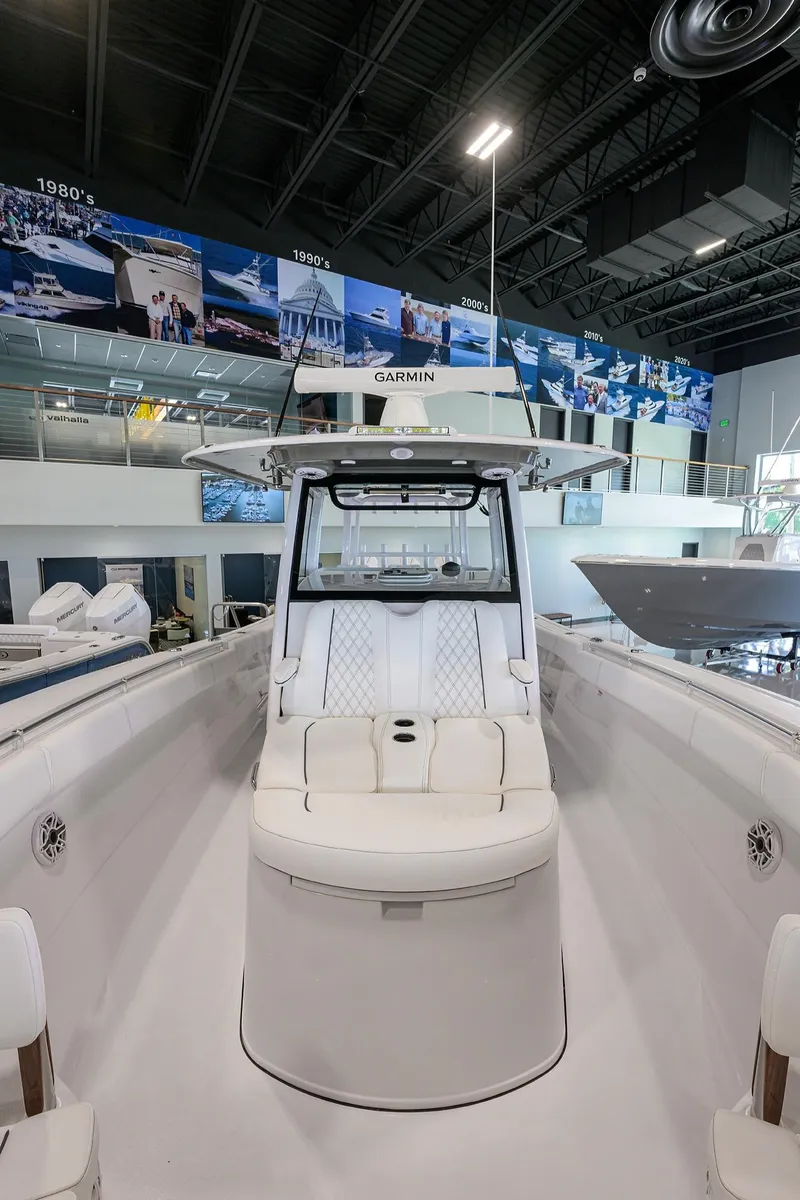Slide: The Image of 2025 Sportsman Open 352 boat displayed in a showroom with modern interior design. - 11