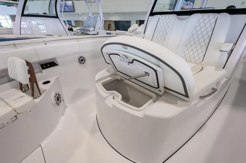 Slide: The Image of 2025 Sportsman Open 352 boat interior with open storage compartment and luxurious seating. - 12