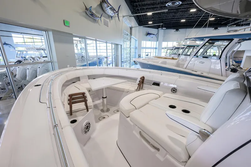 Slide: The Image of 2025 Sportsman Open 352 boat interior with white seating and modern design in showroom. - 16