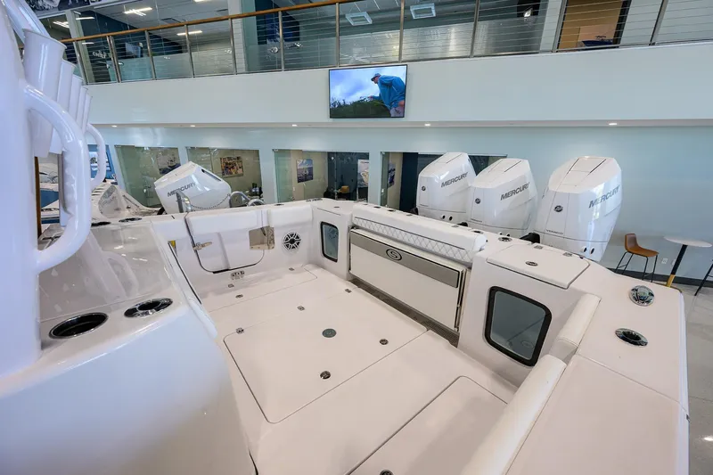 Slide: The Image of 2025 Sportsman Open 352 boat interior with multiple outboard engines in showroom. - 22