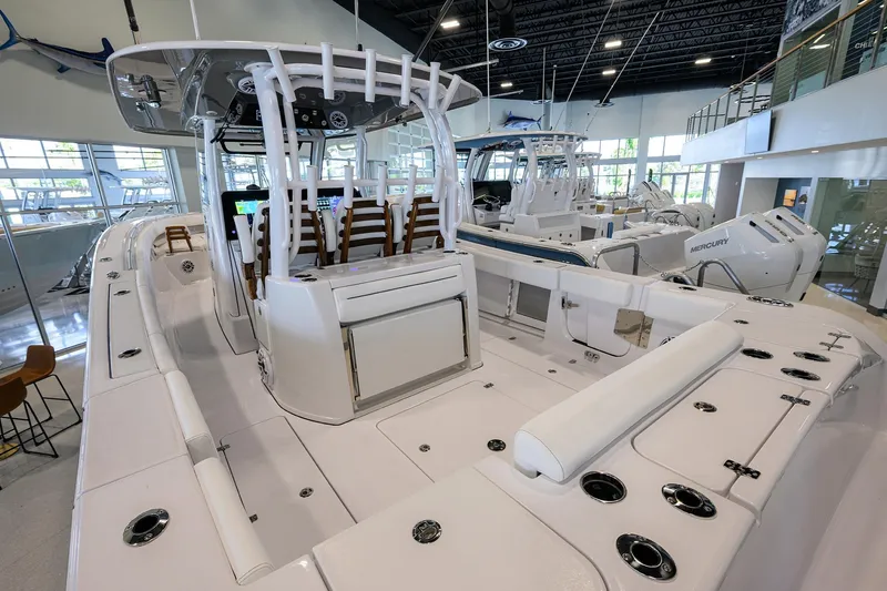 Slide: The Image of 2025 Sportsman Open 352 boat interior, showcasing spacious seating and modern design in a showroom. - 23