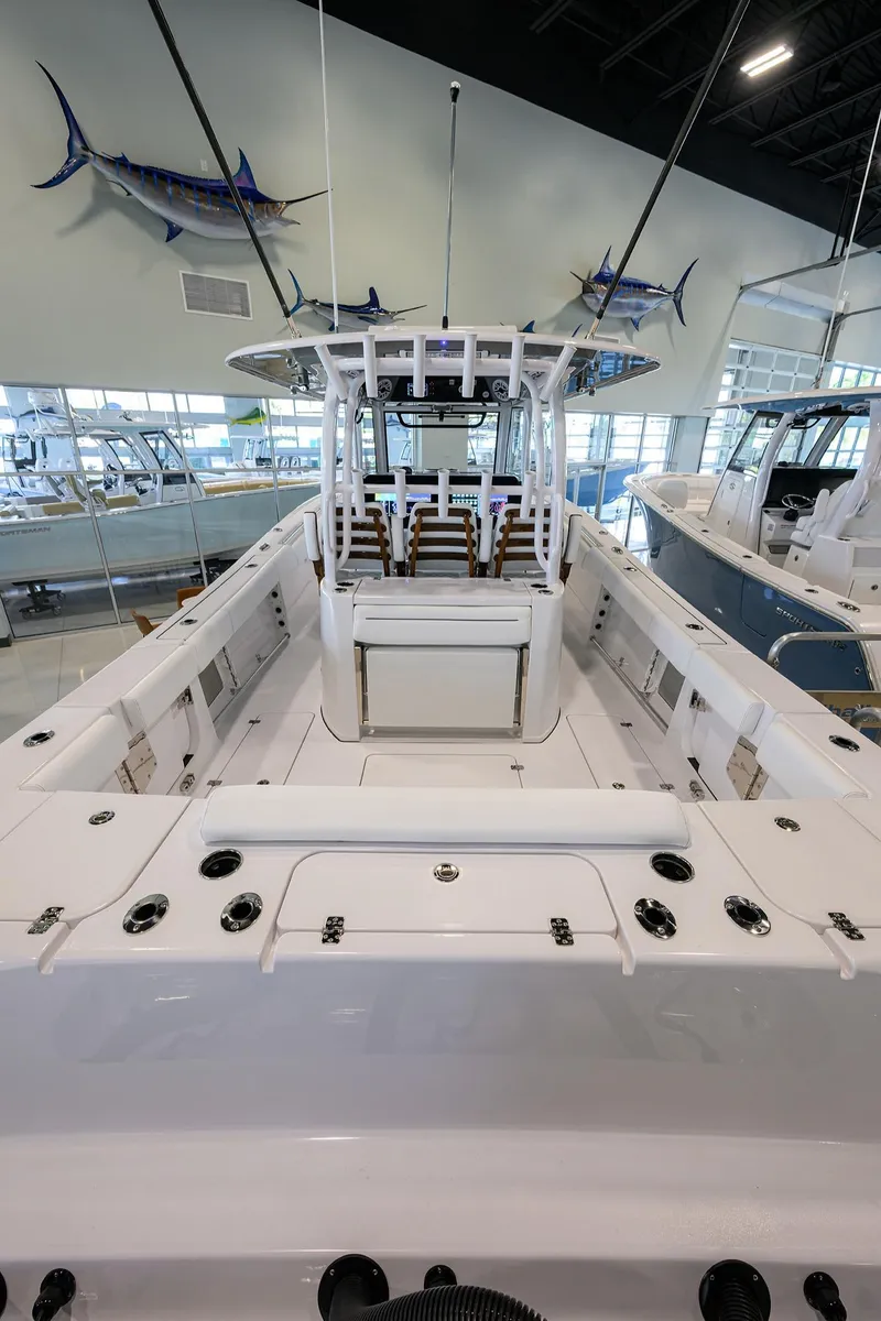 Slide: The Image of 2025 Sportsman Open 352 boat interior with seating, displayed in a showroom. - 24
