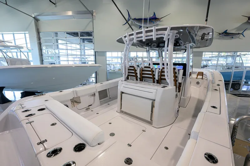 Slide: The Image of 2025 Sportsman Open 352 boat interior with seating and modern helm in showroom. - 25