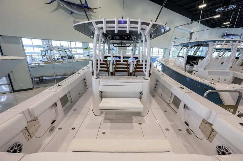 Slide: The Image of 2025 Sportsman Open 352 boat interior, showcasing spacious seating and modern design in a showroom. - 28