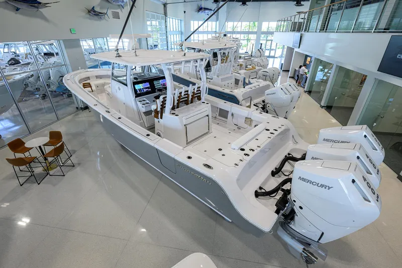 Slide: The Image of 2025 Sportsman Open 352 boat in showroom with triple Mercury engines. - 3