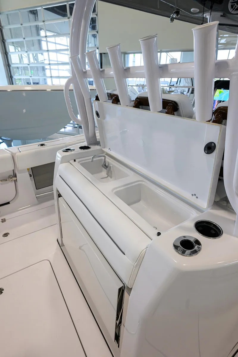 Slide: The Image of 2025 Sportsman Open 352 boat interior with rod holders and storage compartments. - 30