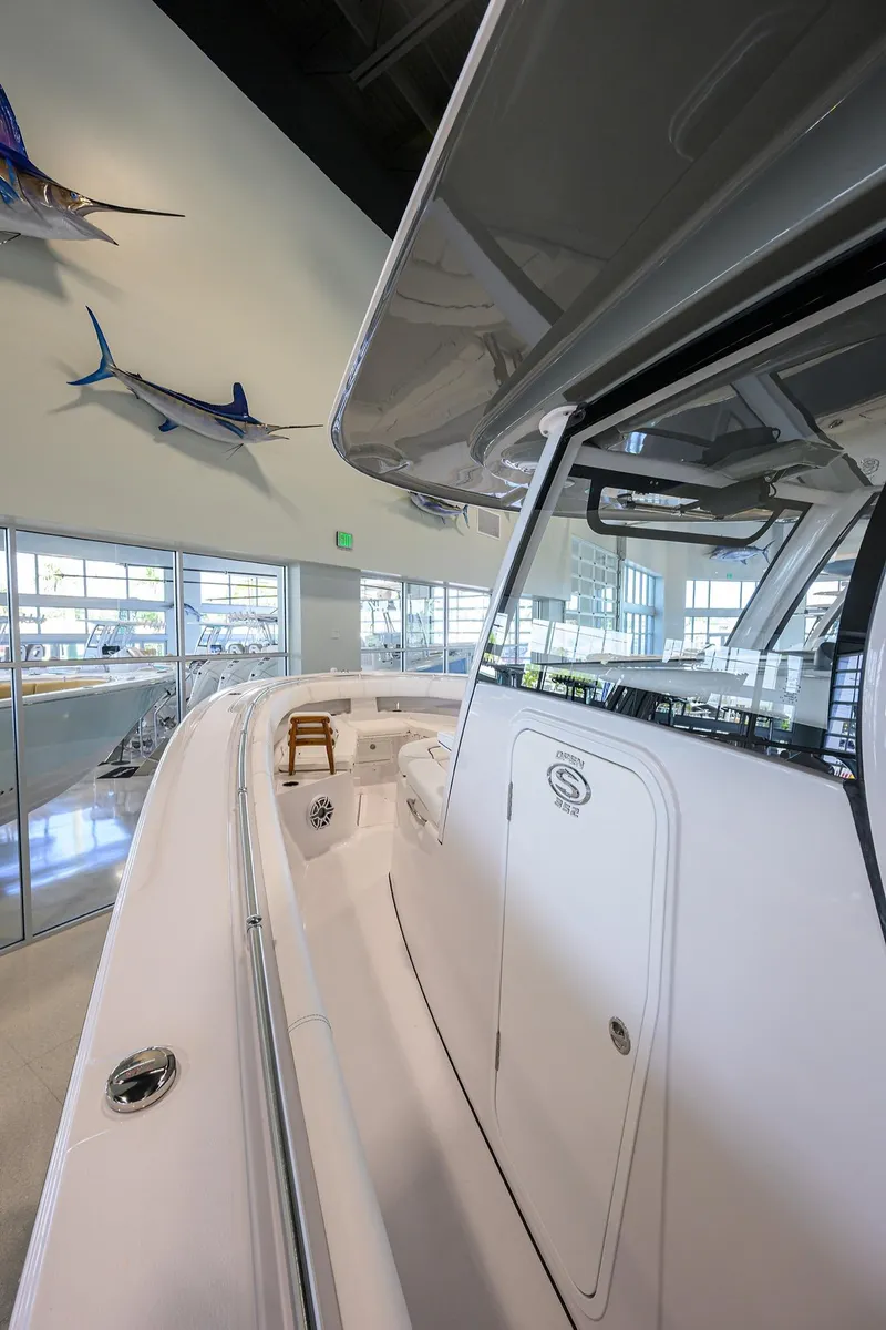 Slide: The Image of 2025 Sportsman Open 352 boat interior with sleek design and mounted fish displays. - 4