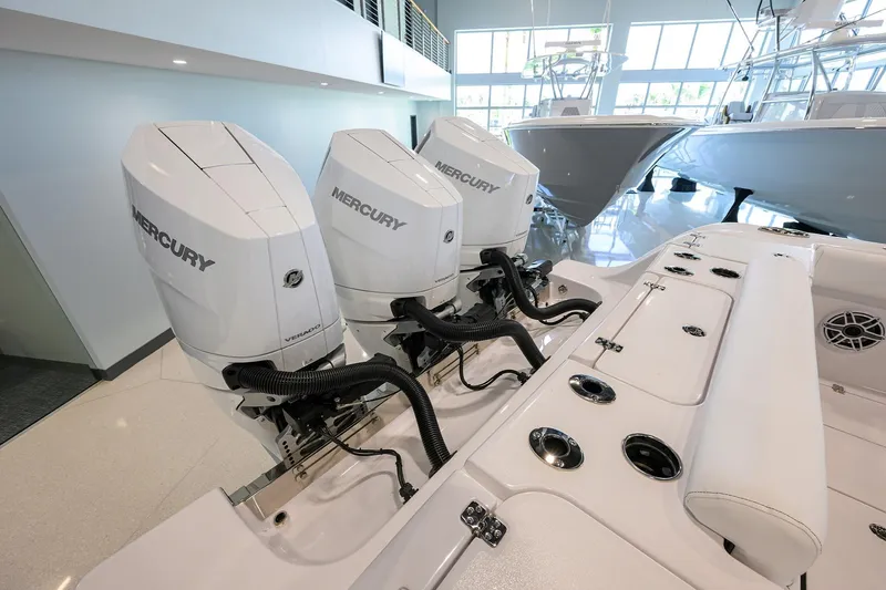 Slide: The Image of 2025 Sportsman Open 352 boat with triple Mercury outboard engines in showroom. - 47
