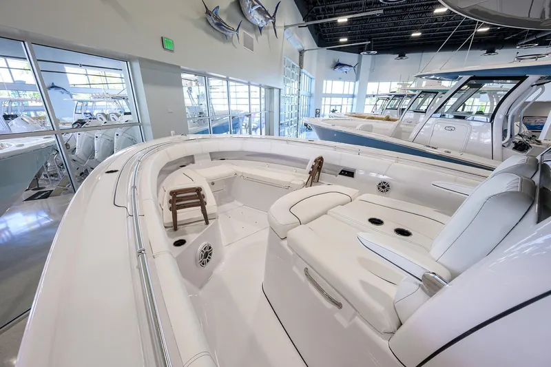Slide: The Image of 2025 Sportsman Open 352 boat interior with luxurious seating in a showroom. - 5
