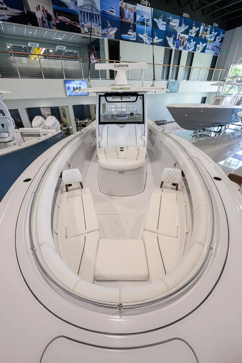 Slide: The Image of 2025 Sportsman Open 352 boat interior with sleek white seating and modern design. - 9