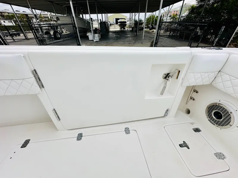 Slide: The Image of 2004 Intrepid 370 Open boat interior with white deck and storage compartments. - 11