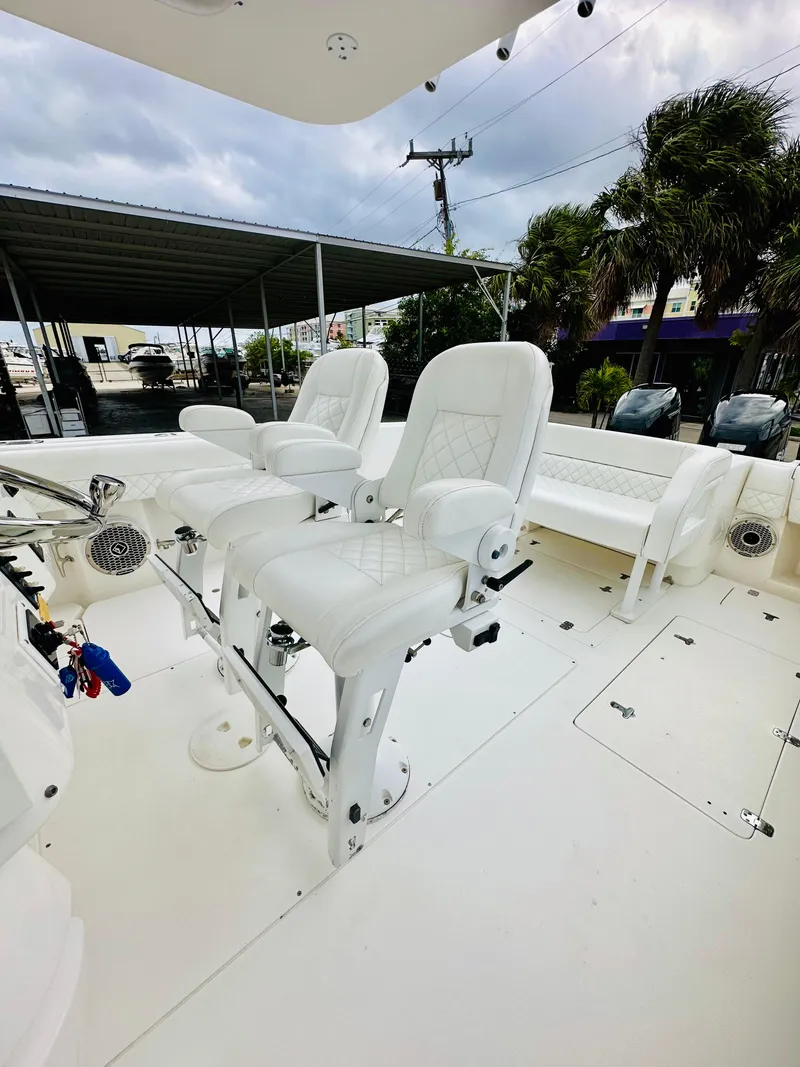 Slide: The Image of 2004 Intrepid 370 Open boat with white seating and spacious deck. - 15