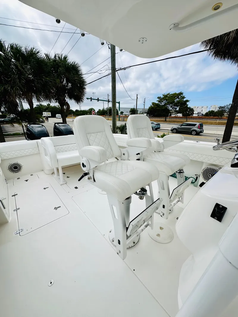 Slide: The Image of 2004 Intrepid 370 Open boat with white seating and coastal view. - 19