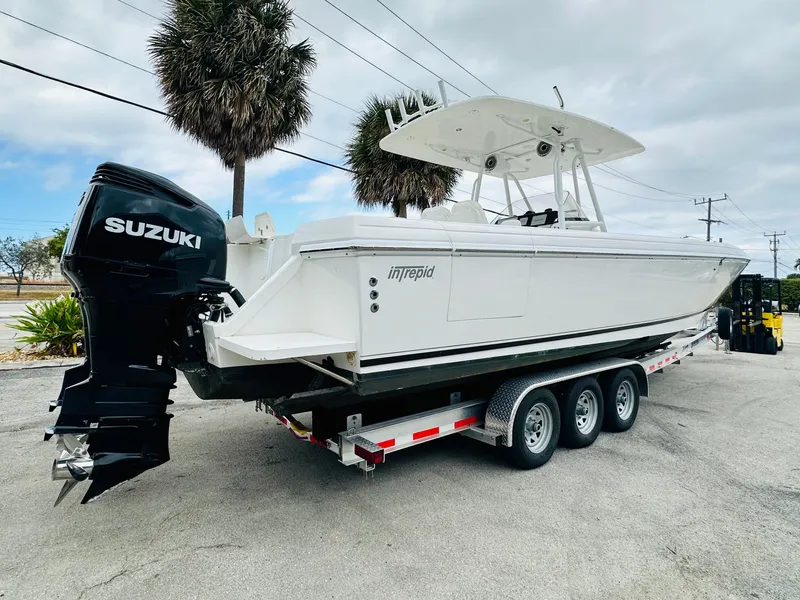 Slide: The Image of 2004 Intrepid 370 Open boat on trailer with Suzuki outboard motor. - 2
