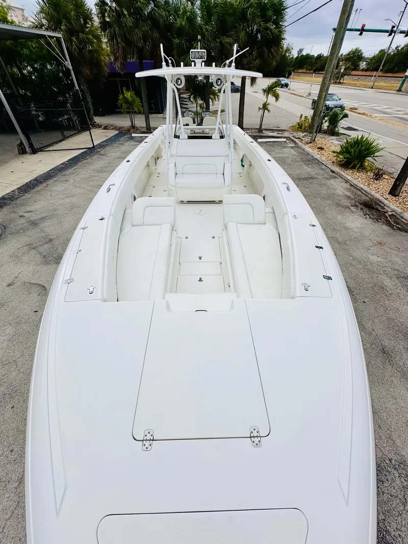 Slide: The Image of 2004 Intrepid 370 Open boat, white exterior, docked on a concrete surface. - 21