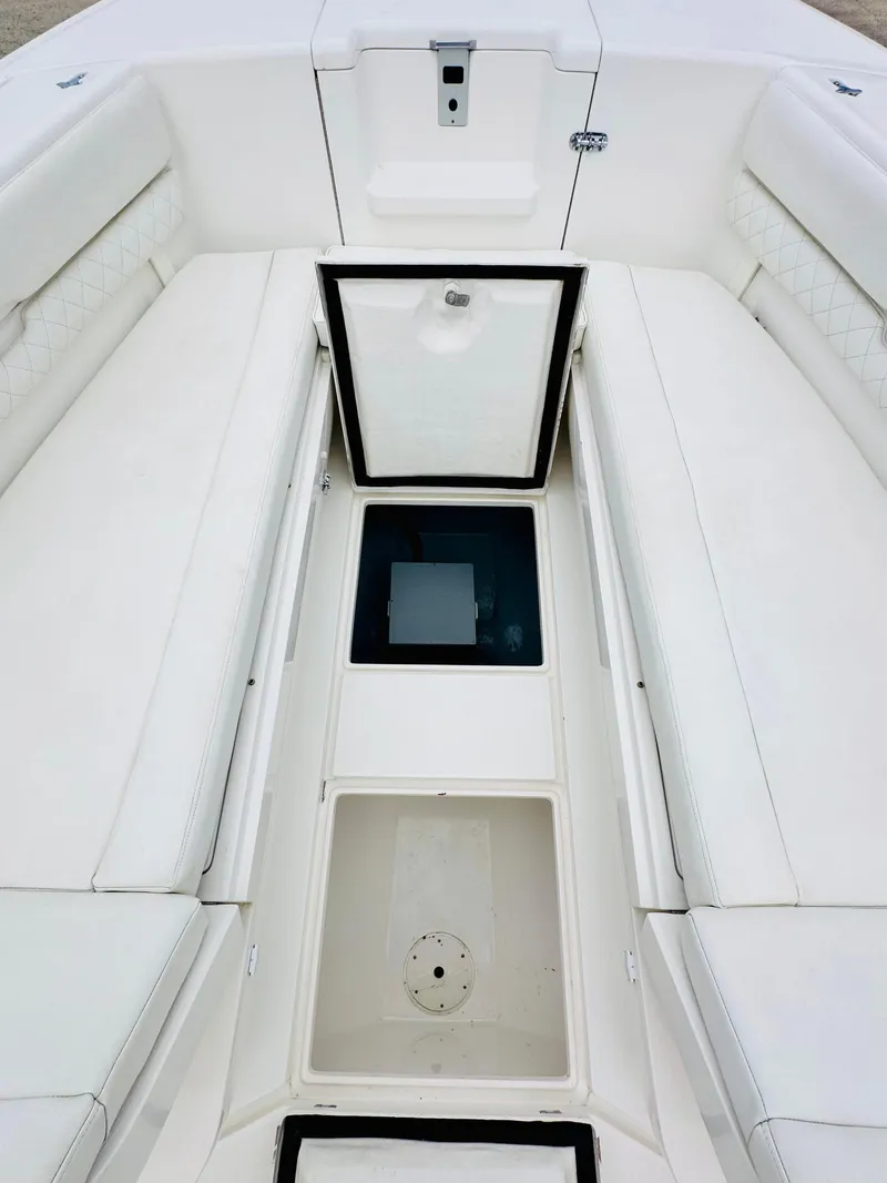 Slide: The Image of 2004 Intrepid 370 Open boat interior with open storage compartments. - 23