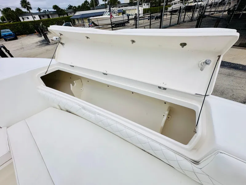 Slide: The Image of Open storage compartment on 2004 Intrepid 370 Open boat, dockside view. - 24