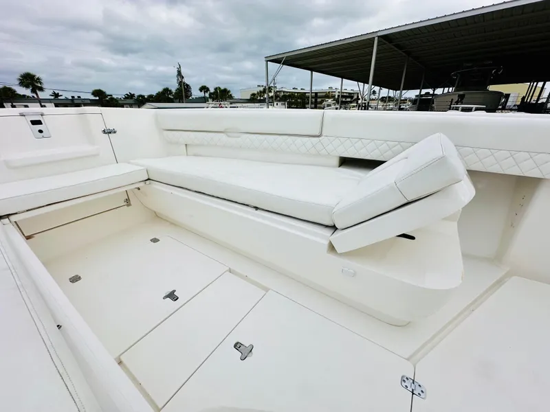 Slide: The Image of 2004 Intrepid 370 Open boat interior with white seating and storage compartments. - 27