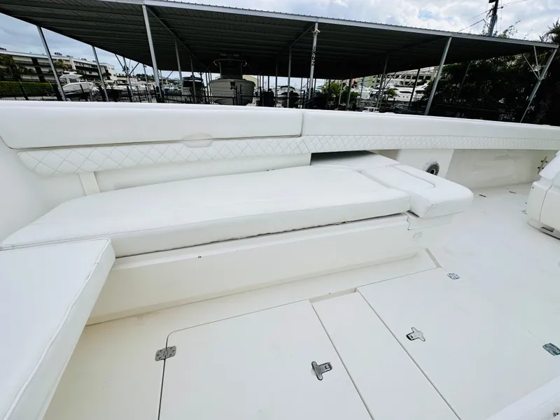 Slide: The Image of 2004 Intrepid 370 Open boat interior with white seating and storage compartments. - 28