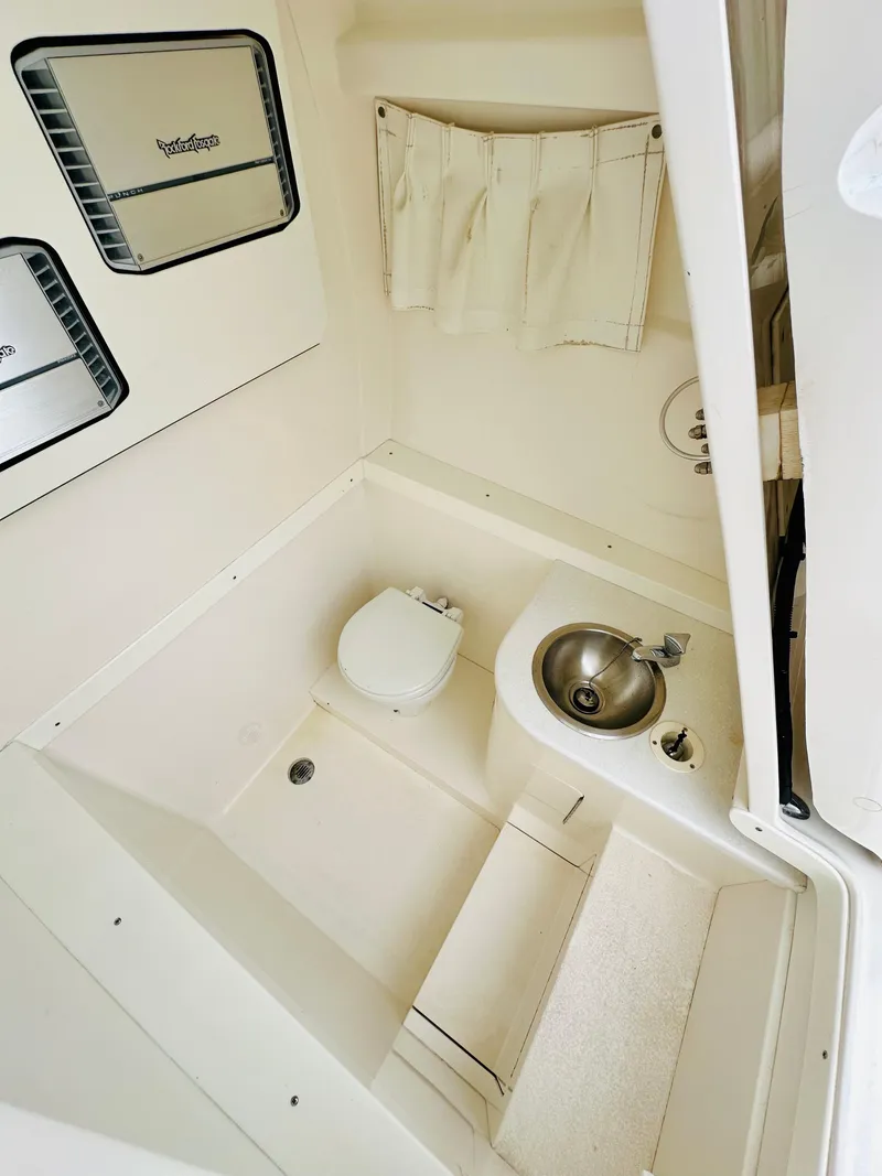 Slide: The Image of 2004 Intrepid 370 Open boat bathroom with toilet and sink. - 30