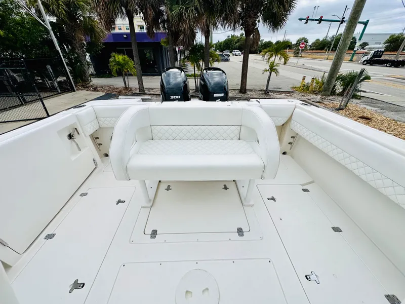 Slide: The Image of 2004 Intrepid 370 Open boat interior with seating and dual engines. - 9