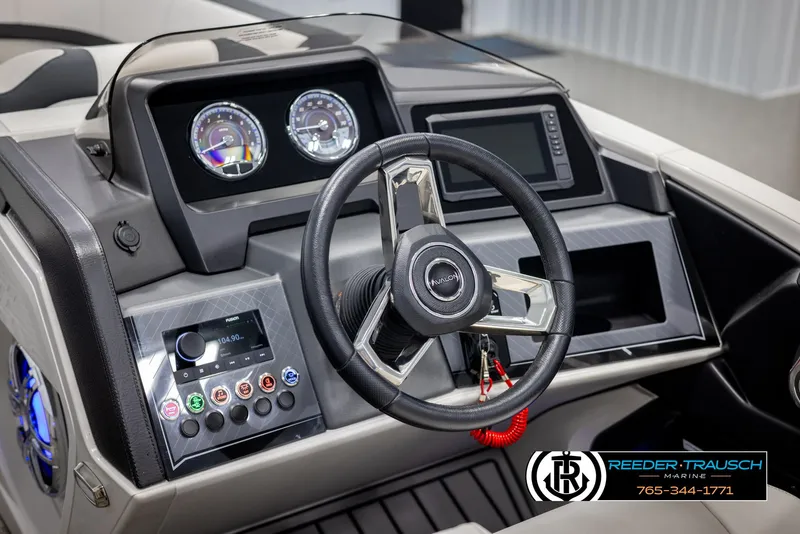 Slide: The Image of 2025 Avalon Catalina QL boat dashboard with steering wheel and control panel. - 28