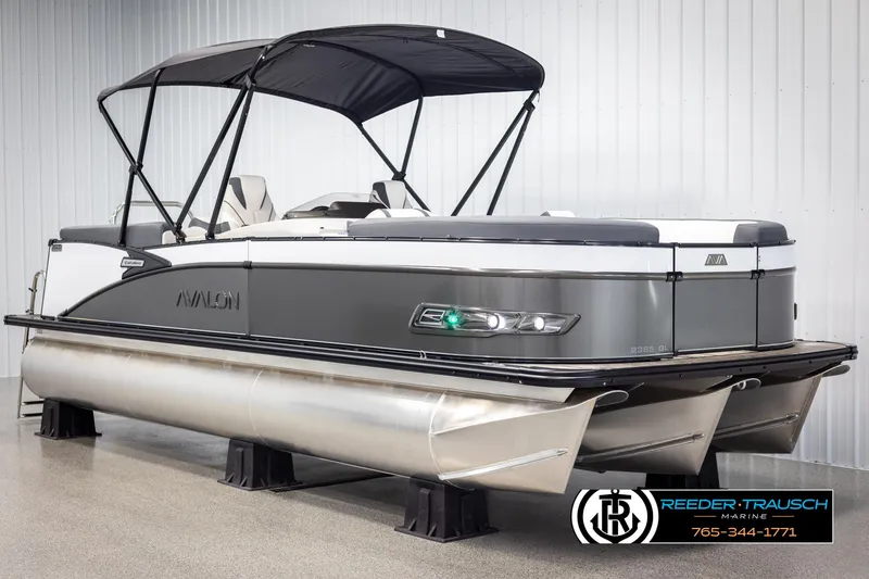 Slide: The Image of 2025 Avalon Catalina QL pontoon boat with canopy, displayed indoors at Reeder-Trausch Marine. - 3