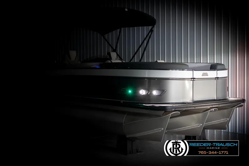 Slide: The Image of 2025 Avalon Catalina QL pontoon boat in showroom, featuring sleek design and modern lighting. - 4