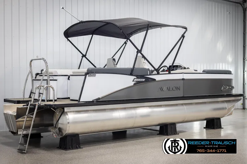 Slide: The Image of 2025 Avalon Catalina QL pontoon boat with canopy in showroom, featuring sleek design and modern amenities. - 6