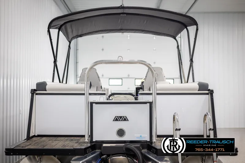 Slide: The Image of 2025 Avalon Catalina QL pontoon boat in showroom, rear view with canopy and seating. - 7