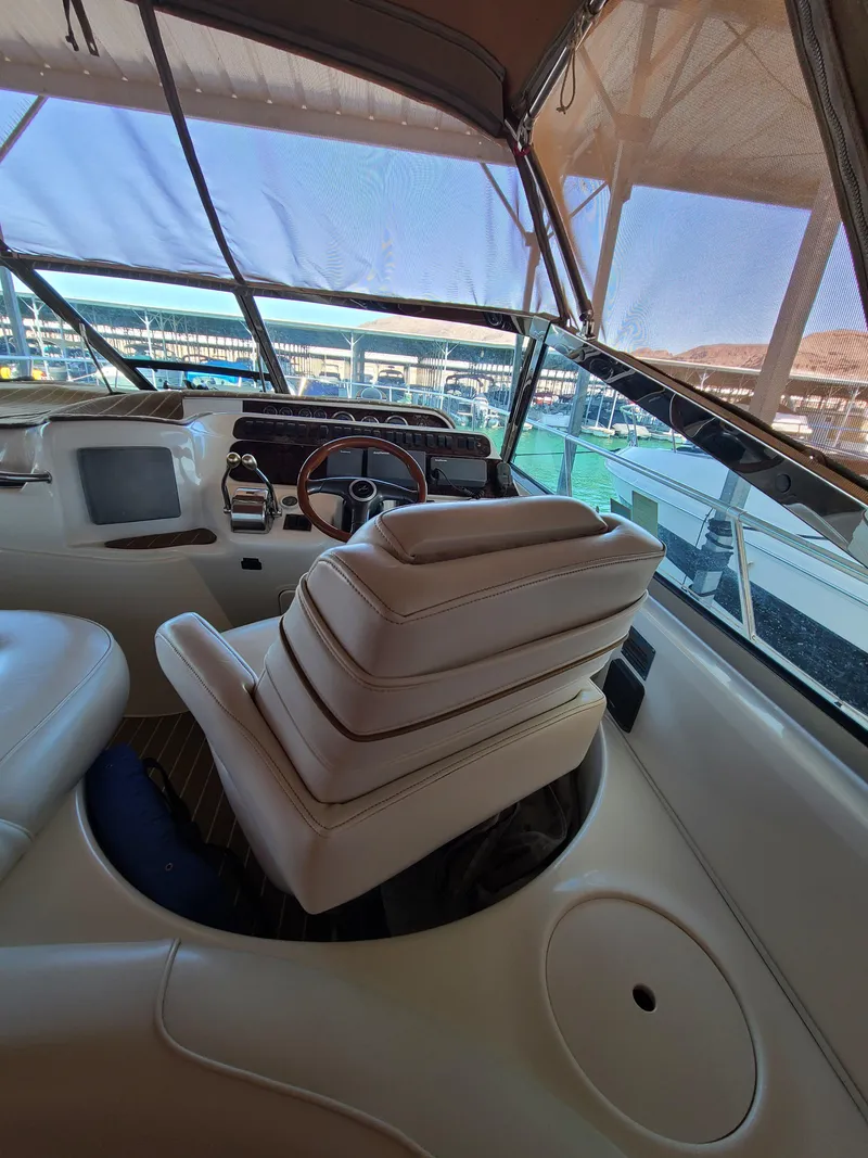 Slide: The Image of 1998 Sea Ray 400 Sundancer yacht interior with helm and seating. - 10