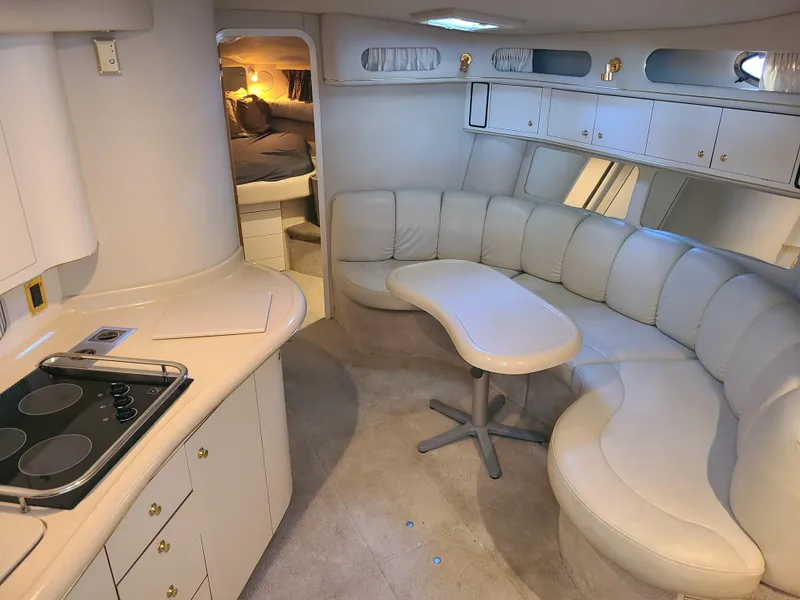 Slide: The Image of Luxurious interior of 1998 Sea Ray 400 Sundancer yacht with curved seating and kitchenette. - 12