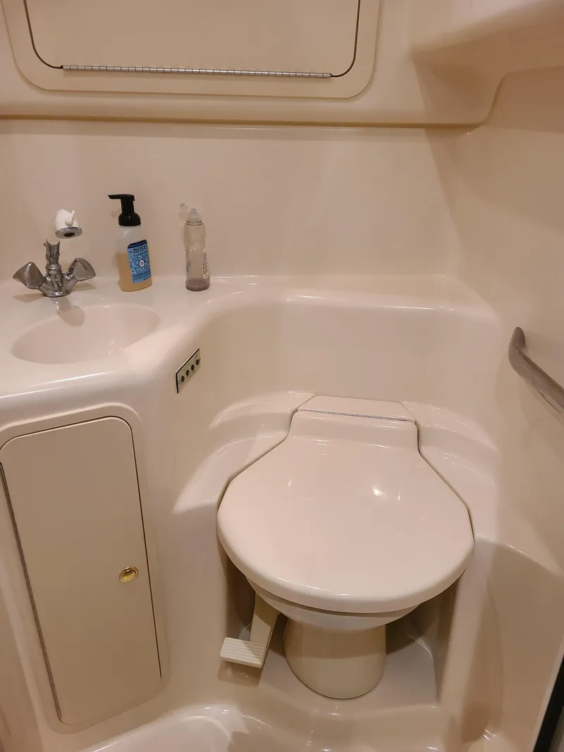 Slide: The Image of 1998 Sea Ray 400 Sundancer bathroom with toilet and sink. - 15