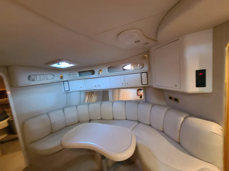 Slide: The Image of Luxurious interior of 1998 Sea Ray 400 Sundancer yacht with curved seating and table. - 18