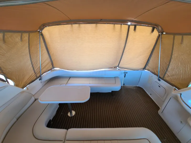 Slide: The Image of Interior of 1998 Sea Ray 400 Sundancer with seating and table under canopy. - 6