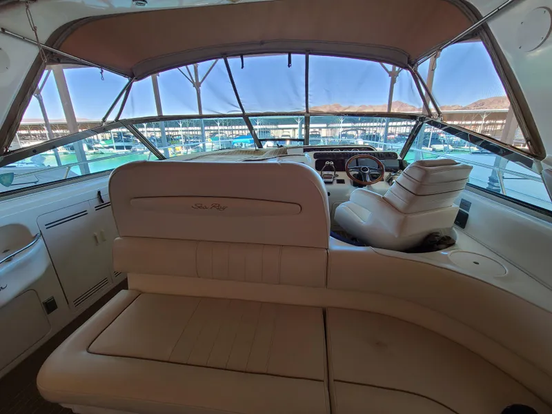 Slide: The Image of Interior view of 1998 Sea Ray 400 Sundancer yacht with helm and seating area. - 7