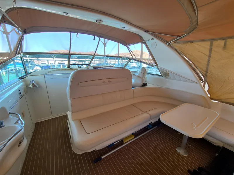 Slide: The Image of Interior of 1998 Sea Ray 400 Sundancer yacht with beige seating and table. - 8