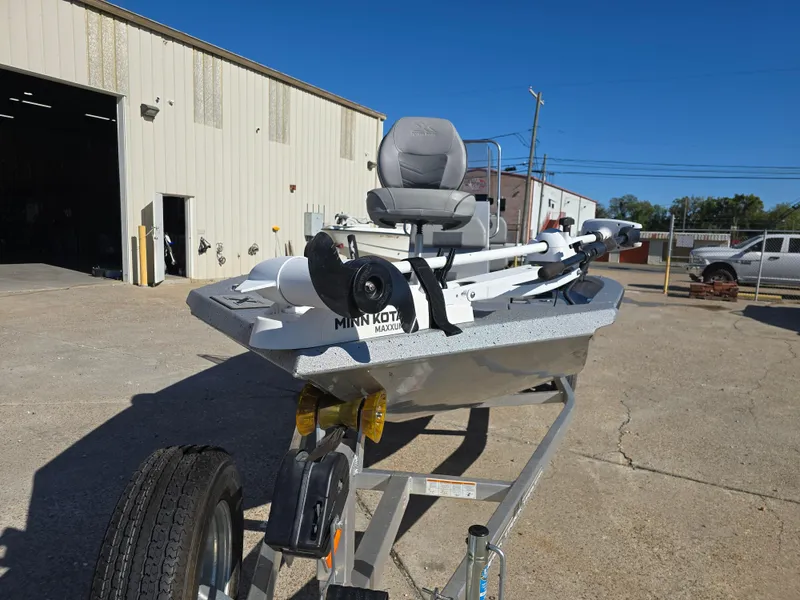 Slide: The Image of 2022 Xpress H20B boat on trailer outside industrial building. - 13