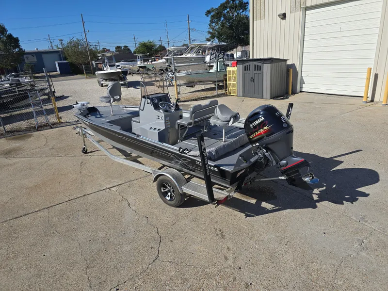 Slide: The Image of 2022 Xpress H20B boat with Yamaha outboard motor on trailer in sunny lot. - 6