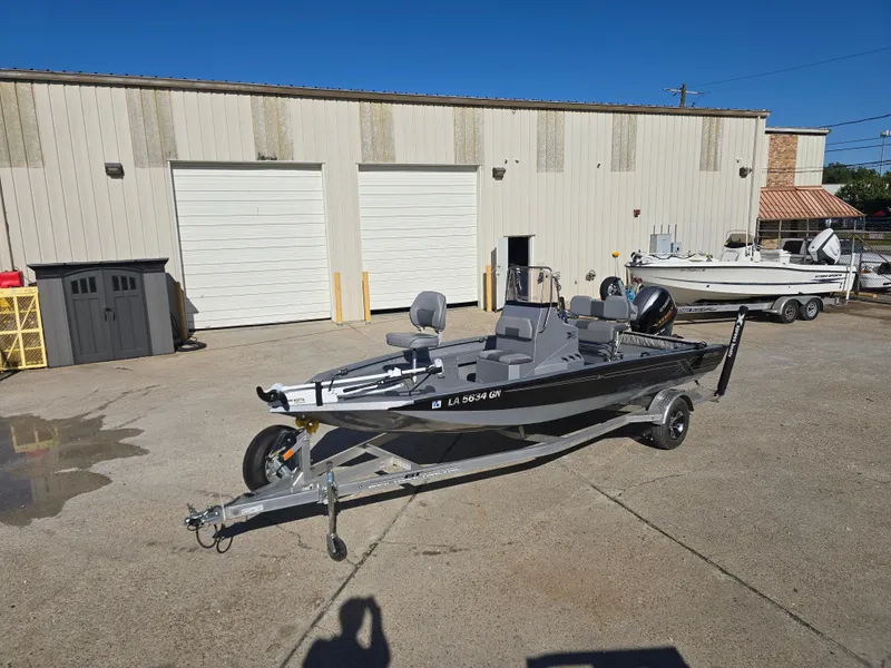 Slide: The Image of 2022 Xpress H20B boat on trailer in industrial lot. - 8