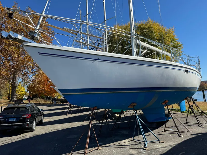 Slide: The Image of 2004 Catalina 42 MkII sailboat on stands, blue hull, autumn trees in background. - 15
