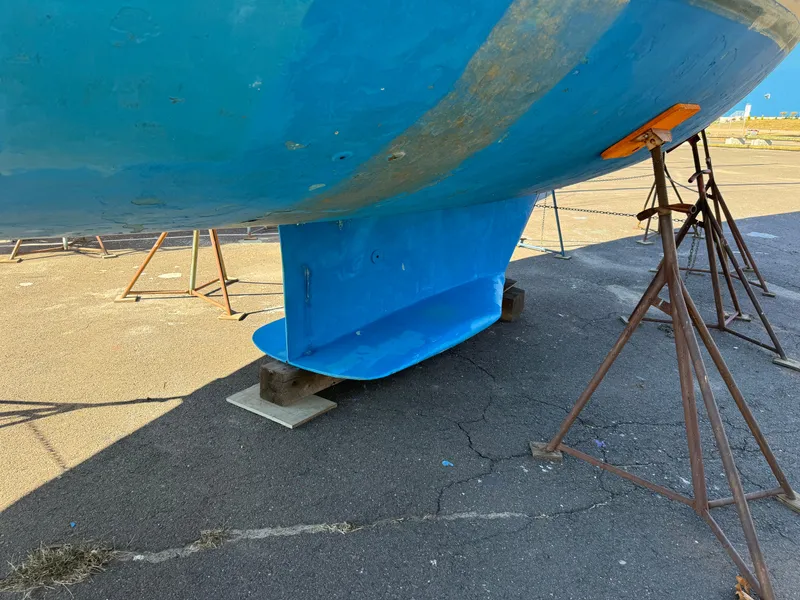 Slide: The Image of Blue hull of 2004 Catalina 42 MkII sailboat on stands, showing keel detail. - 17