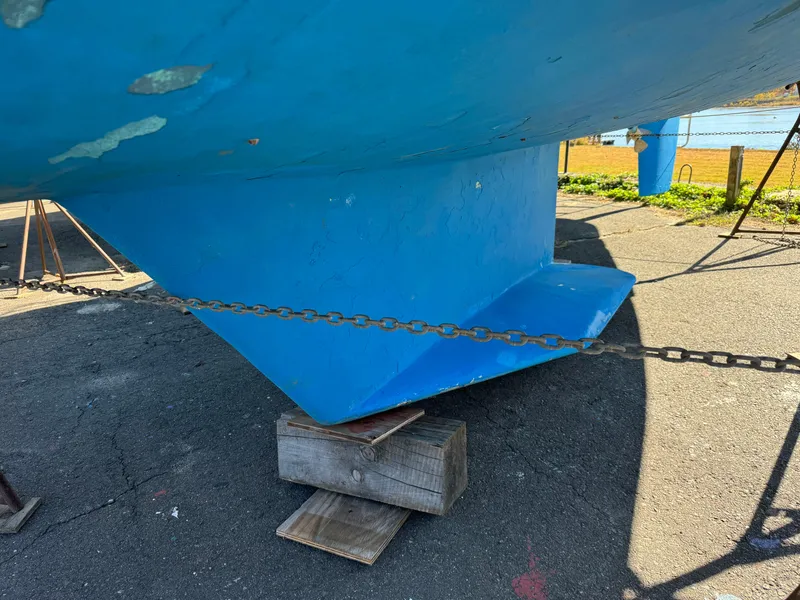 Slide: The Image of Catalina 42 MkII 2004 sailboat keel on blocks, blue hull, outdoor setting. - 20
