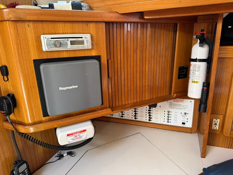Slide: The Image of 2004 Catalina 42 MkII navigation station with Raymarine equipment and fire extinguisher. - 43