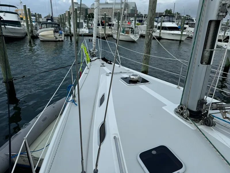 Slide: The Image of 2004 Catalina 42 MkII sailboat docked in marina, surrounded by other boats. - 8